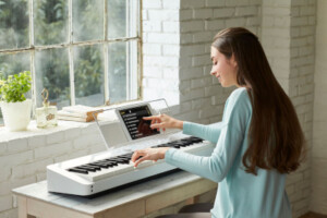 woman plaing electric piano