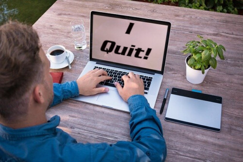 man at computer with I Quit on screen