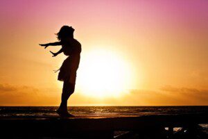 Women in silhouette before a rising sun